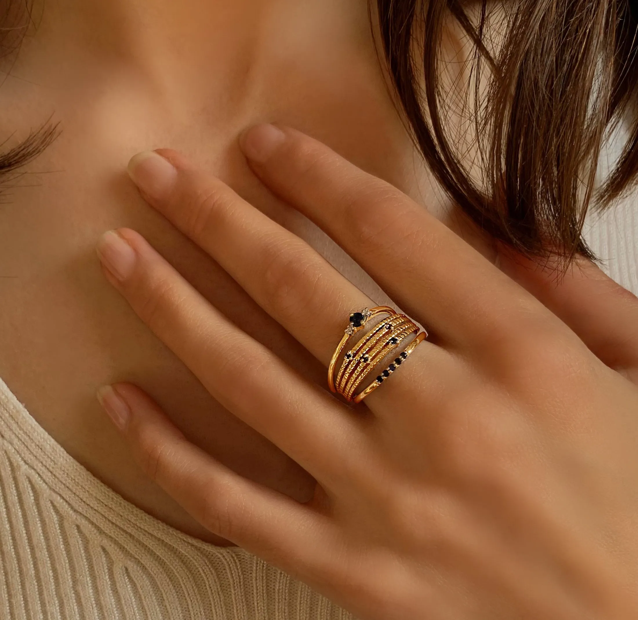 Composition of rings in 925 Silver gilded with 18k yellow gold assembled with blue Sapphire and Zirconium Oxide